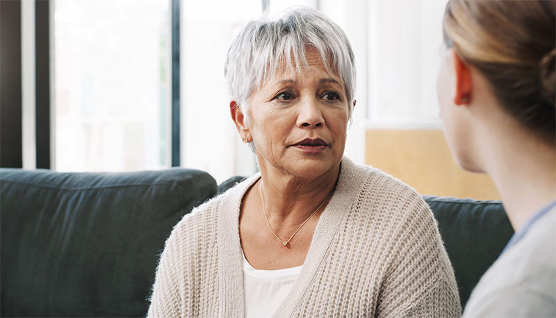 concerned-senior-woman-talking-with-caregiver